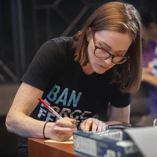 Woman signing a document