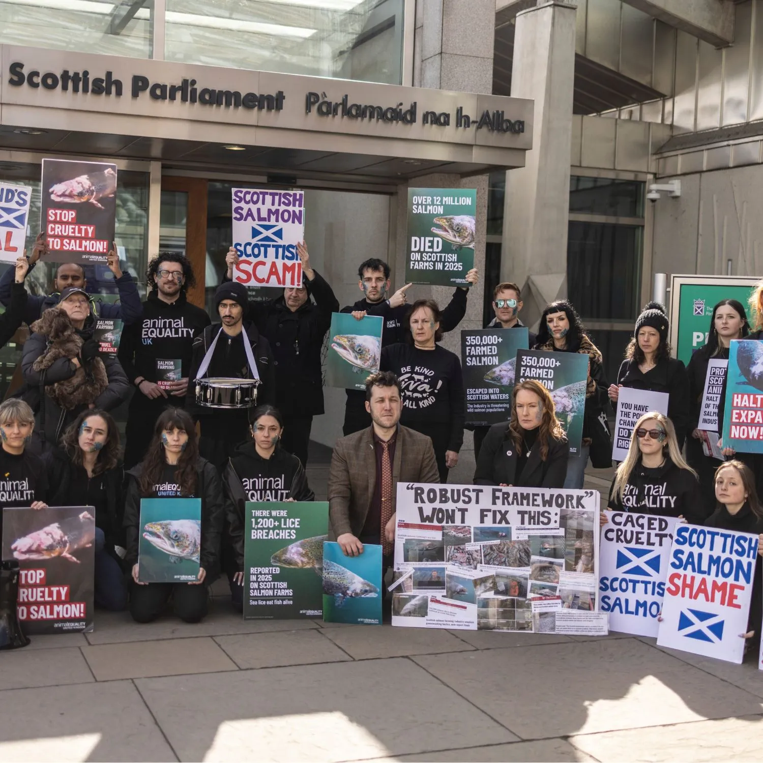 Activists in front of Scottish Parliament protesting salmon farming