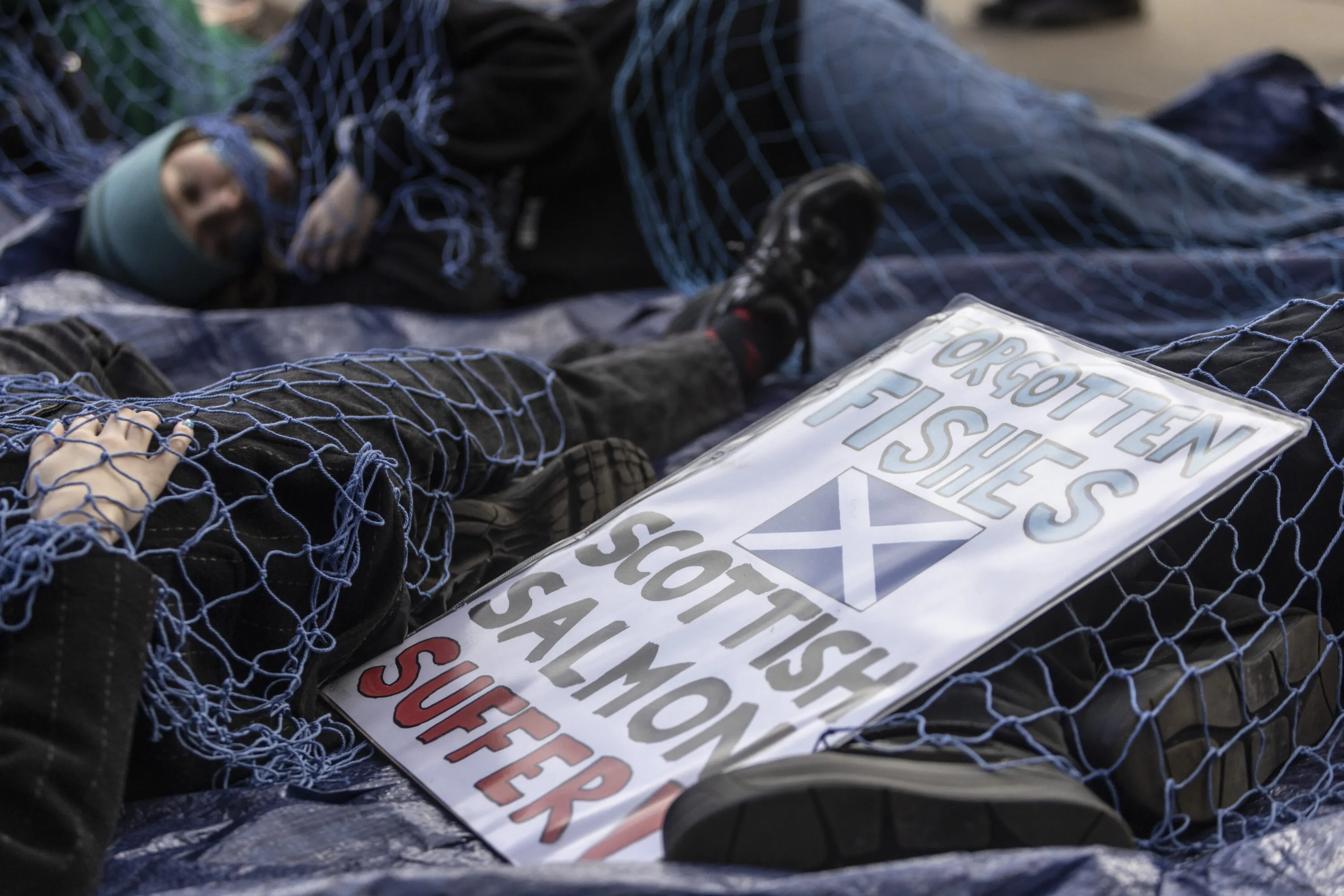 Animal Equality protests, calling on the Scottish Government to halt salmon farm expansion through exposing the suffering of millions of animals trapped in the industry, outside the Scottish Parliament, in Edinburgh, Scotland, 25 March 2026.