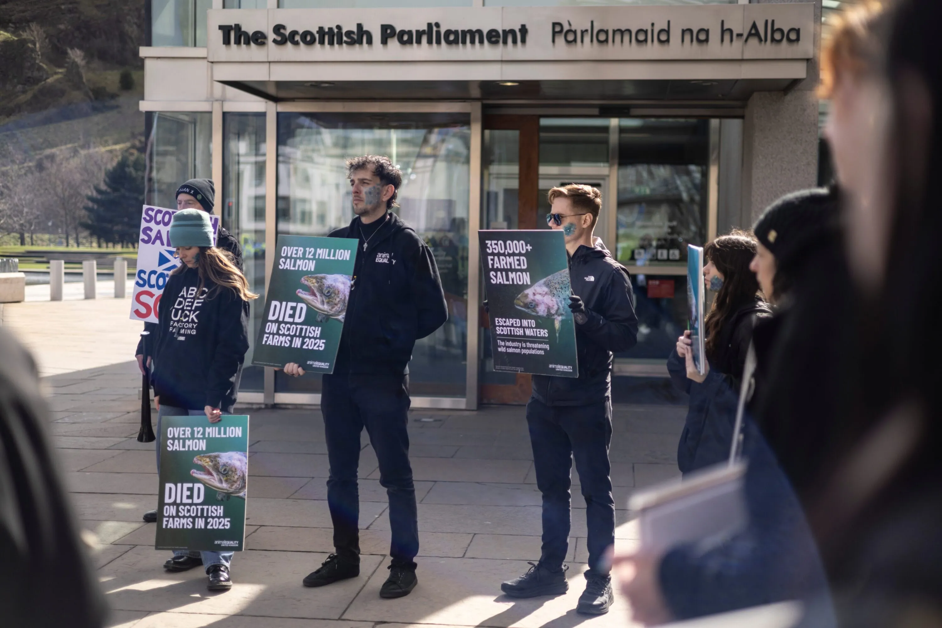 Activists at protest against salmon farming in front of The Scottish parliament