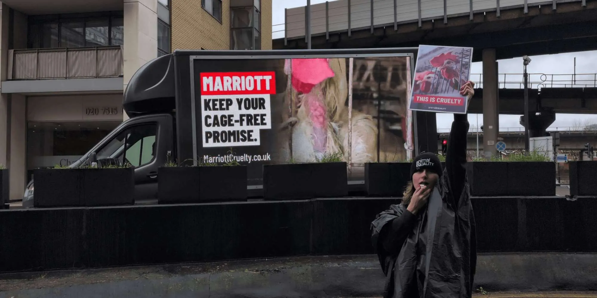 Activist in front of outdoor van protesting Marriott