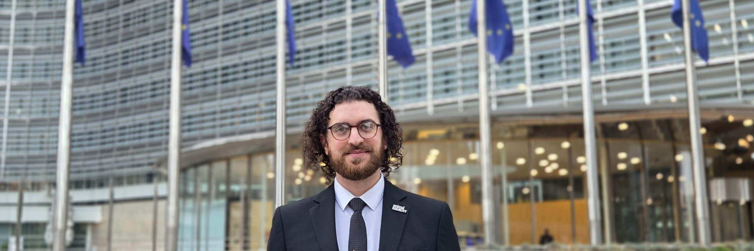 Animal Equality UK team member in front of Brussels EU Parliament